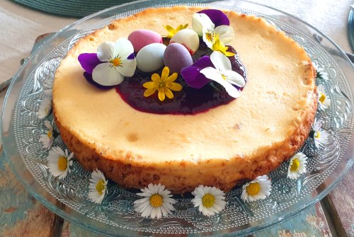 Creamy cheesecake with berry sauce & edible flowers