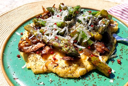 Green asparagus on a polenta plate with king oyster mushrooms